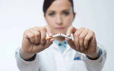 Dentist breaking cigarette in half