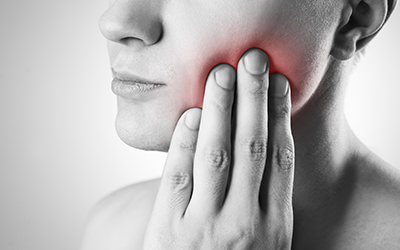 Woman pressing hand on side of mouth