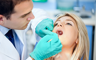 Young woman sitting in a dental chair having work done on her teeth