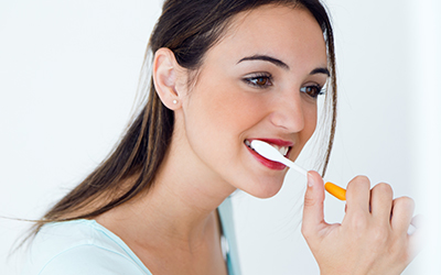 Young woman brushing her teeth